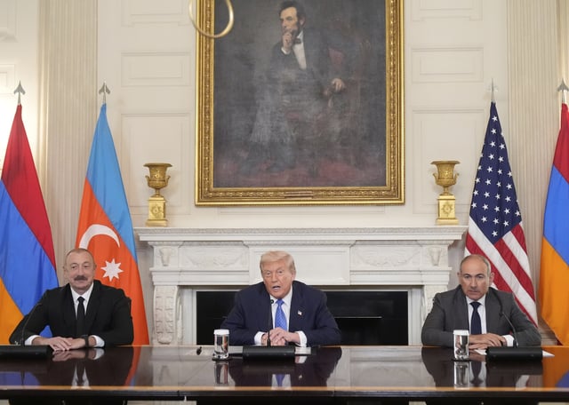 President Donald Trump, center, sits during a trilateral signing with Azerbaijan's President Ilham Aliyev, left, and Armenia's Prime Minister Nikol Pashinyan in the State Dining Room of the White House, Friday, Aug. 8, 2025, in Washington. (AP Photo/Mark Schiefelbein)