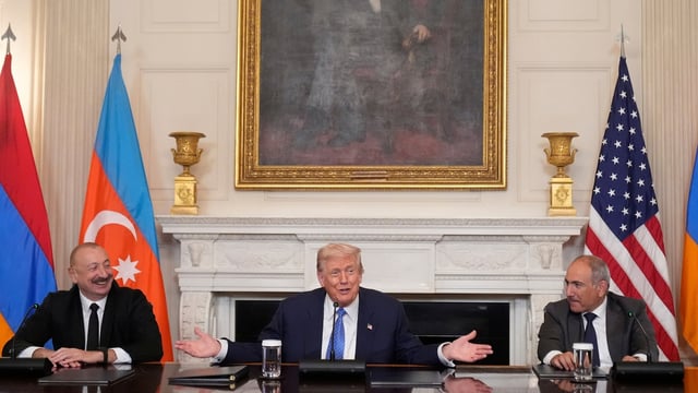 President Donald Trump, center, joined by Armenian Prime Minister Nikol Pashinyan, right, and Azerbaijan President Ilham Aliyev, speaks during a trilateral signing ceremony in the State Dining Room of the White House, Friday, Aug. 8, 2025, in Washington. 