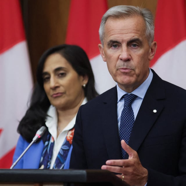 Canada's Prime Minister Mark Carney speaks at a press conference about recognizing Palestinian statehood, while Foreign Affairs Minister Anita Anand listens, in Ottawa, Ontario, Canada, July 30, 2025.  REUTERS/Patrick Doyle