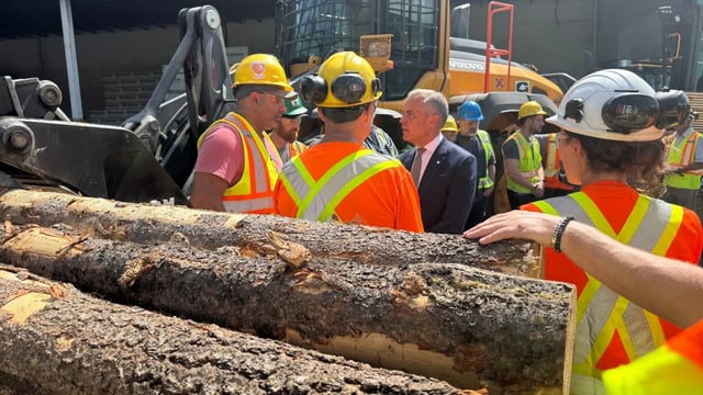 Prime Minister Mark Carney speaks to mill workers in West Kelowna, B.C., after announcing support for Canada's lumber industry on Aug. 5, 2025.