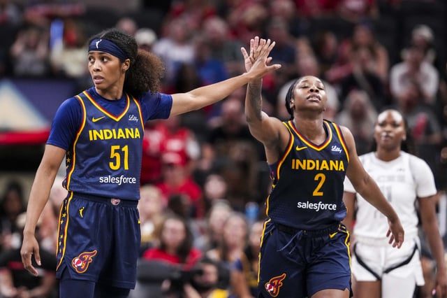 July 3, 2025; Indianapolis, Indiana, USA; Indiana Fever guards Sydney Colson (51) high-fives Aari McDonald (2) during a game against the Las Vegas Aces at Gainbridge Fieldhouse. Mandatory Credit: Grace Smith/INDIANAPOLIS STAR-Imagn Images/File Photo