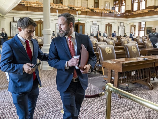 Texas House Speaker, Dustin Borrow, R - Lubbock, right, speaks with House Rep. Briscoe Cain, R - Deer Park, following a Republican Caucus meeting at the State Capitol, Friday, Aug. 8, 2025, in Austin, Texas. (AP Photo/Rodolfo Gonzalez)