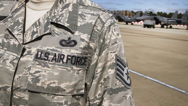 A United States Air Force (USAF) insignia decorates an officer’s uniform near a Boeing Co. F15-E Strike Eagle combat aircraft of the 48th Fighter Wing while taking part in the joint NATO exercise ”Point Blank” from their base at RAF Lakenheath, near Brandon, Suffolk, U.K., on Thursday, June 27, 2019. ‘Point Blank’ focuses on fourth and fifth generation aircraft integration across three nations with a total of 48 aircraft meeting in the skies over the North Sea, said Lt. Col. Jason Watkins, commander of the 48th Operations Support Squadron. Photographer: Simon Dawson/Bloomberg via Getty Images
