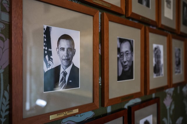 This photo taken on September 25, 2024 shows a portrait of former US president Barack Obama, Nobel Peace Prize laureate of 2009, next to other photographs of laureates on a wall of the committee meeting room at the Norwegian Nobel Institute in Oslo, Norway.