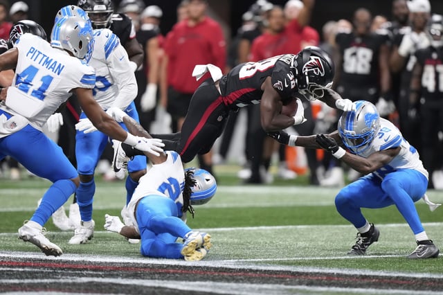 Detroit Lions safety Morice Norris  is hit in the helmet by Atlanta Falcons running back Nathan Carter (38) during the second half of an NFL preseason football game Friday.