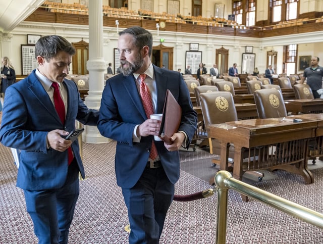 Texas House Speaker, Dustin Borrow, R - Lubbock, right, speaks with House Rep. Briscoe Cain, R - Deer Park, following a Republican Caucus meeting at the State Capitol, Friday, Aug. 8, 2025, in Austin, Texas. (AP Photo/Rodolfo Gonzalez)