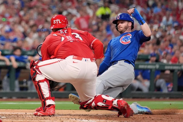 Chicago Cubs’ Ian Happ, right, is tagged out at home by St. Louis Cardinals catcher Pedro Pages during the fourth inning of a baseball game Friday, Aug. 8, 2025, in St. Louis. (AP Photo/Jeff Roberson)