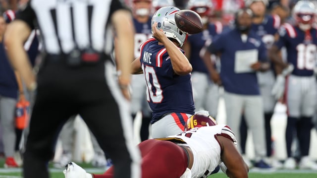 Aug 8, 2025; Foxborough, Massachusetts, USA; Washington Commanders defensive tackle Johnny Newton (95) tackles New England Patriots quarterback Drake Maye (10) during the first half at Gillette Stadium.