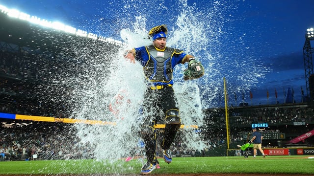 Aug 8, 2025; Seattle, Washington, USA; Seattle Mariners catcher Cal Raleigh (29) is dunked with the cooler after the game against the Tampa Bay Rays at T-Mobile Park. Mandatory Credit: Steven Bisig-Imagn Images