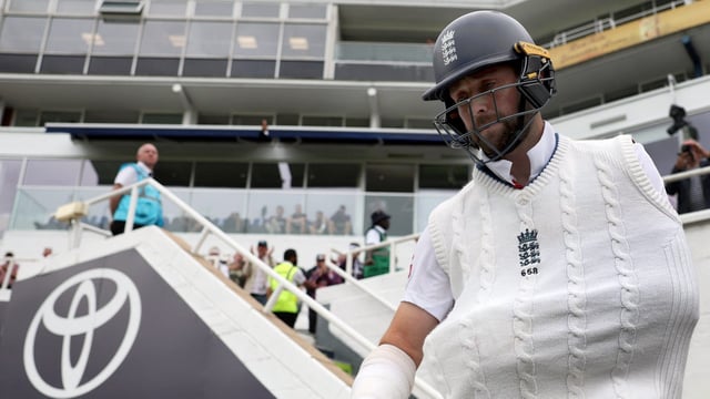 England's Chris Woakes walks out to bat