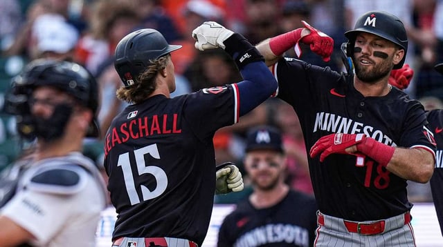 Minnesota Twins second base Luke Keaschall (15), left, celebrates after batting 2-run home run against Detroit Tigers during the first inning at Comerica Park in Detroit in Tuesday, August 5, 2025.