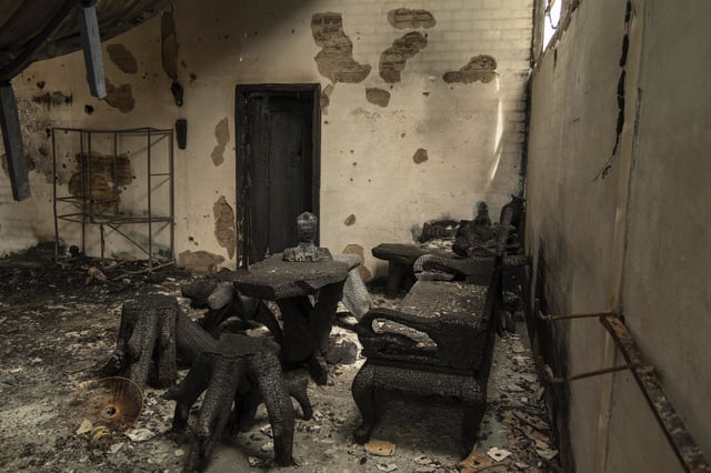 A bust of Buddha among remains charred inside a bombed building in O'Smach, Oddar Meanchey in Cambodia, on Wednesday, July 30, 2025. (AP Photo/Anton L. Delgado)