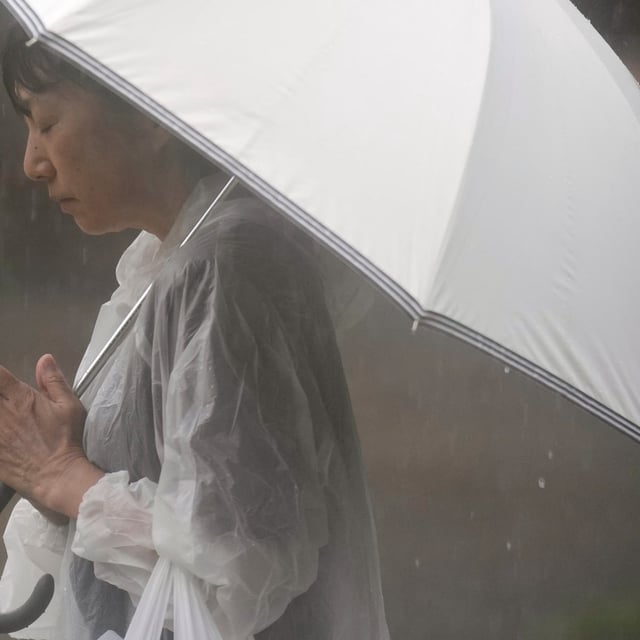 A person prays, ahead of a ceremony to mark the 80th anniversary of the WWII U.S. atomic bombing at Atomic Bomb Hypocenter Park in Nagasaki, western Japan Saturday, Aug. 9, 2025. (AP Photo/Eugene Hoshiko)