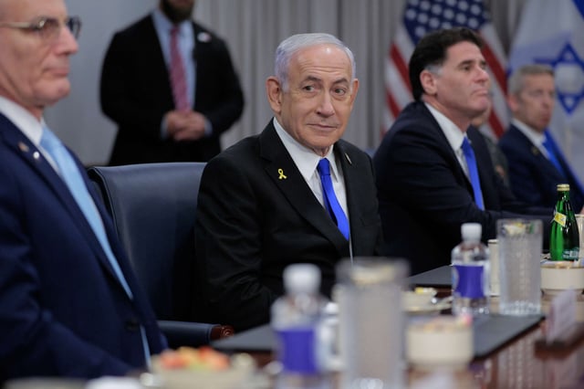 Israeli Prime Minister Benjamin Netanyahu (C) is joined by Israeli ambassador to the U.S. Yechiel "Michael" Leiter (L) and Minister of Strategic Affairs Ron Dermer and other officials for a meeting with U.S. Secretary of Defense Pete Hegseth at the Pentagon on July 9, 2025, in Arlington, Virginia.