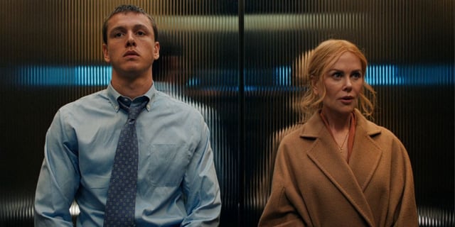 Harris Dickinson and Nicole Kidman standing awkwardly beside one another in an elevator in Babygirl.