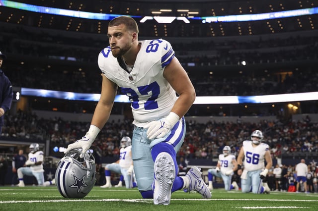 Jake Ferguson #87 of the Dallas Cowboys warms up prior to an NFL football game against the Tampa Bay Buccaneers at AT&amp;T Stadium on December 22, 2024 in Arlington, Texas.