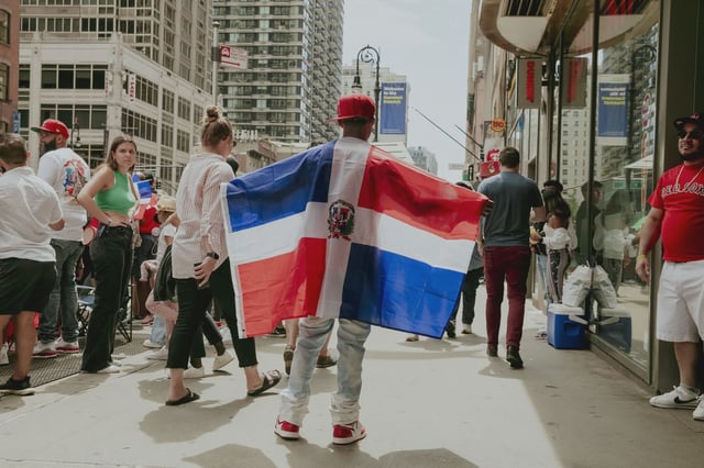 Revelers celebrate the 40th annual National Dominican Day Parade down 6th Avenue in Manhattan.