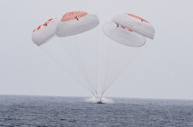 In this image provided by NASA, SpaceX capsule carrying four astronauts, parachutes into the Pacific Ocean off the Southern California coast on Saturday, Aug. 9, 2025.