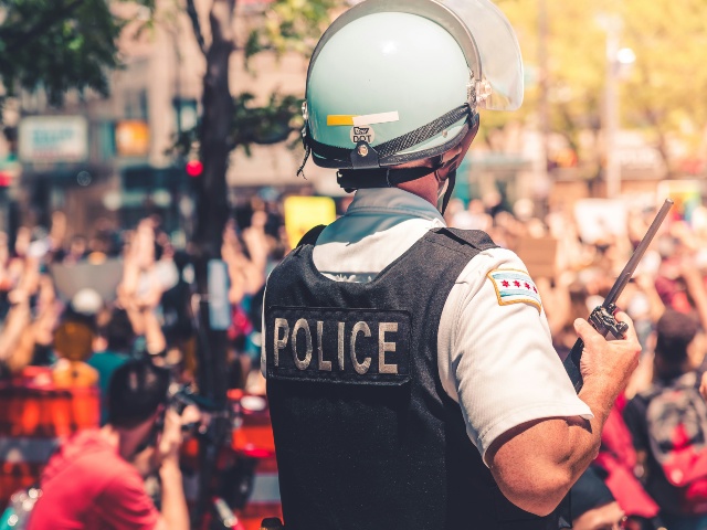 police man in black and white helmet and black vest