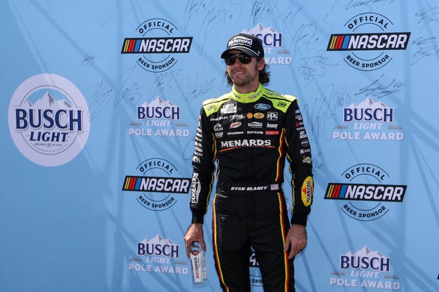 Aug 9, 2025; Watkins Glen, New York, USA; NASCAR Cup Series driver Ryan Blaney (12) stands with the Busch Light Pole Award after winning the pole for the Go Bowling at The Glen at Watkins Glen International. Mandatory Credit: Matthew O'Haren-Imagn Images