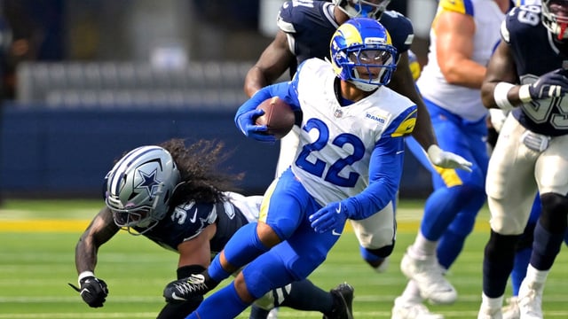 Los Angeles Rams running back Blake Corum (22) runs past Dallas Cowboys linebacker Marist Liufau (35) for a first down during the first half at SoFi Stadium. Mandatory Credit: Jayne Kamin-Oncea-Imagn Images