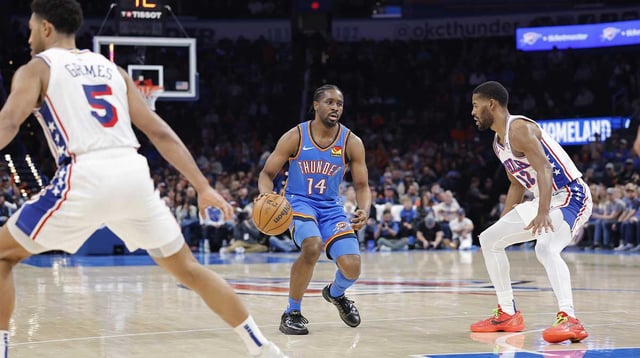 Mar 19, 2025; Oklahoma City, Oklahoma, USA; Oklahoma City Thunder forward Adam Flagler (14) dribbles down the court beside Philadelphia 76ers guard Jared Butler (12) during the second half at Paycom Center. Mandatory Credit: Alonzo Adams-Imagn Images