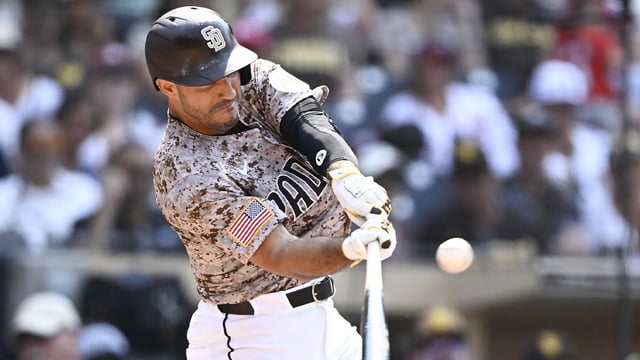 Aug 3, 2025; San Diego, California, USA; San Diego Padres right fielder Ramon Laureano (5) hits a solo home run during the eighth inning against the St. Louis Cardinals at Petco Park. Mandatory Credit: Denis Poroy-Imagn Images