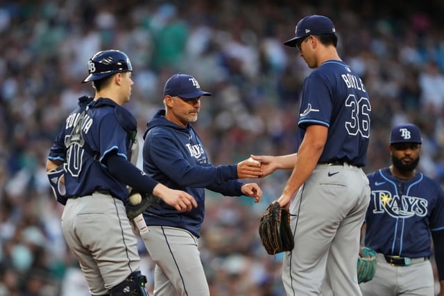 Rays manager Kevin Cash comes out to take starting pitcher Joe Boyle (36) out of the game against the Mariners as catcher Hunter Feduccia looks on during the fourth inning Saturday in Seattle. (AP Photo/Lindsey Wasson)