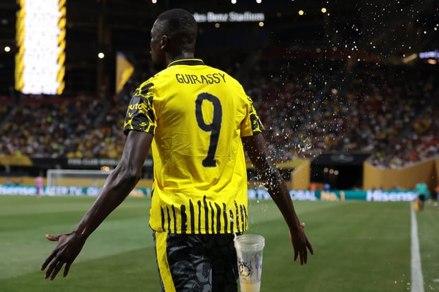 Plastic cups pass close to Serhou Guirassy of Borussia Dortmund as he celebrates after scoring to give the side a 1-0 lead during the FIFA Club World Cup 2025 round of 16 match between Borussia Dortmund and CF Monterrey at Mercedes-Benz Stadium on July 01, 2025 in Atlanta, Georgia.
