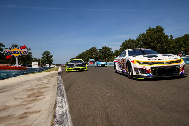Shane Van Gisbergen, driver of the #88 WeatherTech Chevrolet, and Ryan Blaney, driver of the #12 Menards/Richmond Water Heaters Ford, lead the field on a pace lap prior to the NASCAR Cup Series Go Bowling at The Glen at Watkins Glen International on August 10, 2025, in Watkins Glen, New York.