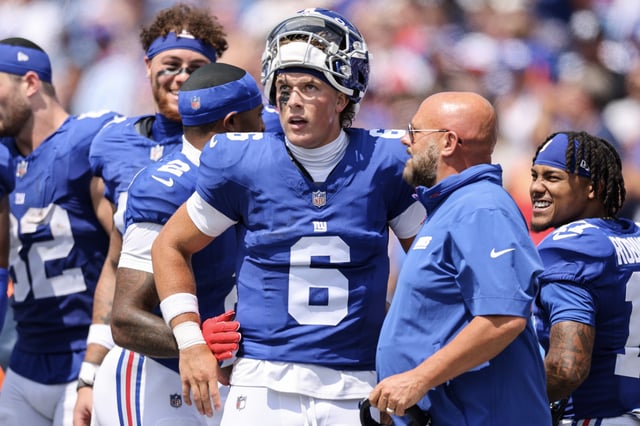 Jaxson Dart #6 of the New York Giants and head coach Brian Daboll speak during the second quarter of an NFL Preseason 2025 game between New York Giants and Buffalo Bills at Highmark Stadium on August 09, 2025 in Orchard Park, New York.
