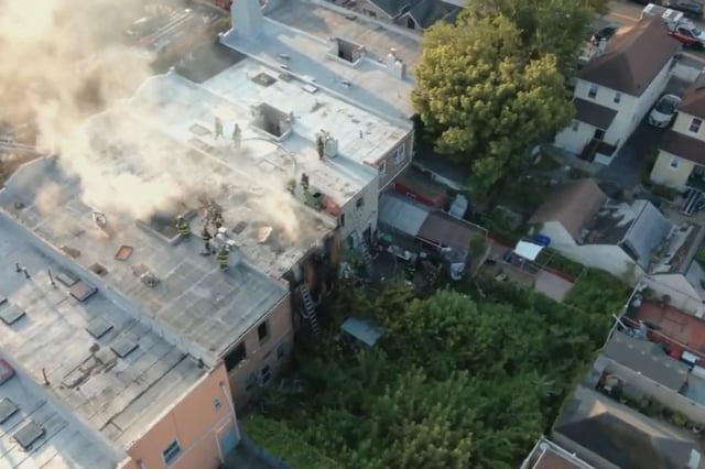 FDNY crews work to extinguish a four-alarm fire on Sutphin Boulevard in Queens.