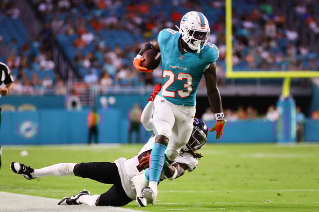 Aug 9, 2024; Miami Gardens, Florida, USA; Miami Dolphins running back Jeff Wilson Jr. (23) runs with the football past Atlanta Falcons safety Lukas Denis (41) during the first quarter at Hard Rock Stadium. Mandatory Credit: Sam Navarro-USA TODAY Sports/File Photo