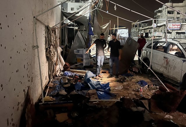 Palestinians inspect the site of an Israeli strike where Al Jazeera says its journalists Anas Al Sharif, Mohammed Qreiqeh and three photojournalists were killed, in Gaza City, August 11, 2025.