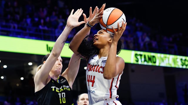 Aug 10, 2025; Arlington, Texas, USA; Washington Mystics forward Kiki Iriafen (44) drives to the basket as Dallas Wings center Luisa Geiselsoder (18) defends during the first half at College Park Center. Mandatory Credit: Chris Jones-Imagn Images