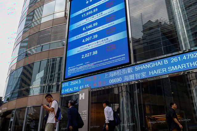 Screens showing the Hang Seng stock index and stock prices are seen outside Exchange Square, in Hong Kong, China, August 18, 2023. REUTERS/Tyrone Siu/File Photo