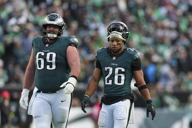 DECEMBER 8: Landon Dickerson #69 and Saquon Barkley #26 of the Philadelphia Eagles look on against the Carolina Panthers at Lincoln Financial Field on December 8, 2024 in Philadelphia, Pennsylvania.