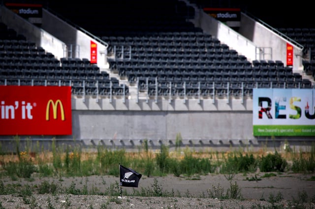 A small flag can be seen in the middle of the severely damaged rugby stadium in the New Zealand city of Christchurch March 11, 2013. A 6.3 magnitude earthquake struck the south island city of Christchurch on February 22, 2011, killing 185 people and leaving most of the central business district being zoned 'uninhabitable'. Picture taken March 11, 2013./File Photo