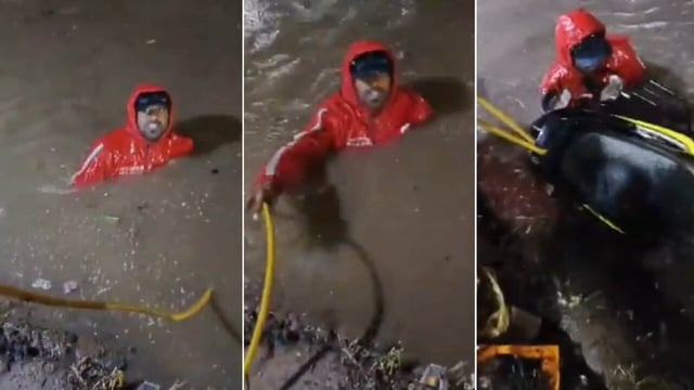 Locals rescue Zomato delivery rider Syed Farhan after he fell into an open drain during heavy rains near TKR Kaman in Hyderabad on August 9.