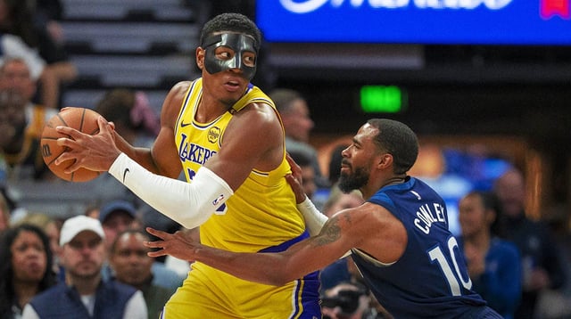 Apr 25, 2025; Minneapolis, Minnesota, USA; Los Angeles Lakers forward Rui Hachimura (28) backs towards the basket as Minnesota Timberwolves guard Mike Conley (10) plays defense in the first half during game three of first round for the 2024 NBA Playoffs at Target Center. Mandatory Credit: Jesse Johnson-Imagn Images