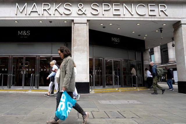 Pedestrians walk past the Marble Arch branch of British retailer Marks & Spencer Plc in central London, Britain, May 18, 2025. REUTERS/Carlos Jasso/File Photo