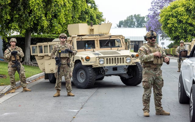 Members of the California National Guard stand guard at the Paramount Business Center parking lot a day after clashes between protesters and law enforcement following multiple detentions by Immigration and Customs Enforcement (ICE), in the Los Angeles County city of Paramount, California, U.S., June 8, 2025.   REUTERS/Jill Connelly/File Photo