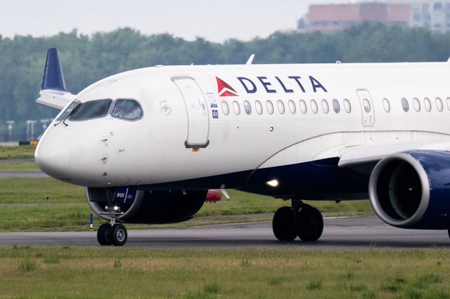A Delta Air Lines Airbus A220 airplane prepares to takeoff at Ronald Reagan Washington National Airport in Arlington, Virginia, on July 10, 2025. Delta Air Lines stock shares surged more than 11 percent in early trading on Thursday,  as the airline reported better-than-expected results. Between April and June, the group posted year-on-year sales of $16.65 billion and net income of $2.13 billion (+63% year-on-year). (Photo by SAUL LOEB / AFP) (Photo by SAUL LOEB/AFP via Getty Images)