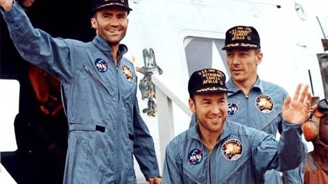 Apollo 13 astronauts, from left, Fred W Haise, Jim Lovell and John Swigert, leave a helicopter to step aboard the USS Iwo Jima on April 17, 1970, after their successful recovery in the Pacific Ocean.