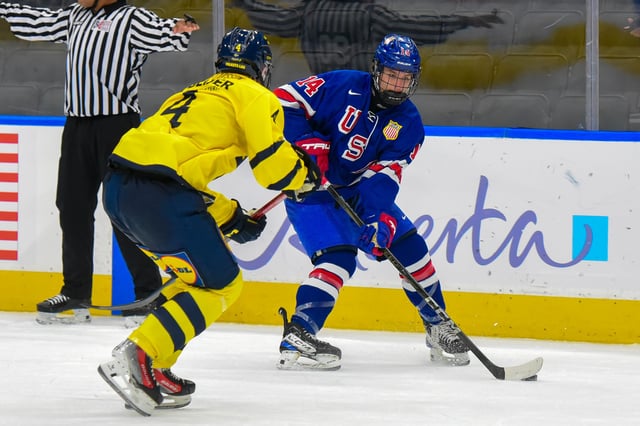 Mason Moe #14 of Team USA skates against Axel Bröngel-Larsson #4 of Team Sweden during the Bronze Medal Game of the 2024 Hlinka Gretzky Cup at Rogers Place on August 10, 2024, in Edmonton, Alberta, Canada.
