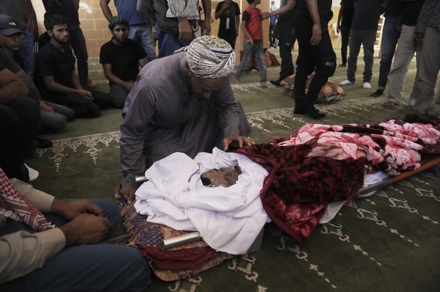 Mourners attend the funeral of Palestinian activist Awdah Al Hathaleen, who was killed by Israeli settler according to Palestinian health officials, in the West Bank Bedouin village of Umm al-Khair, Thursday, Aug. 7, 2025. (AP Photo/Mahmoud Illean)