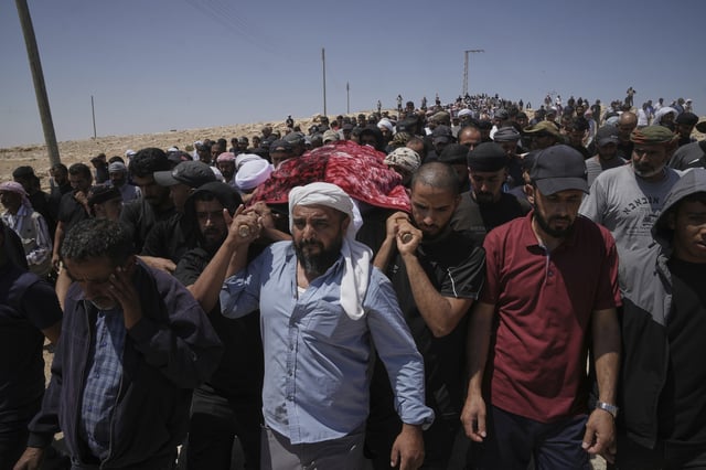Mourners carry the body of Palestinian activist Awdah Al Hathaleen, who was killed by Israeli settler according to Palestinian health officials, during his funeral in the West Bank Bedouin village of Umm al-Khair, Thursday, Aug. 7, 2025. (AP Photo/Mahmoud Illean)