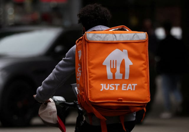 A Just Eat delivery rider cycles through Manchester, Britain, August 23, 2023. REUTERS/Phil Noble/File Photo