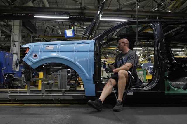 FILE - A vehicle assembly technician works on a 2025 Ford Expedition during a media tour to launch the 2025 Ford Expedition at the Ford Motor Company Kentucky Truck Plant, April 30, 2025, in Louisville, Ky. (AP Photo/Carolyn Kaster, file)