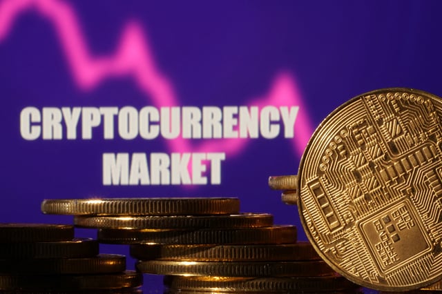 Representations of cryptocurrencies are seen in front of displayed words "Cryptocurrency market" and decreasing stock graph in this illustration taken November 10, 2022. REUTERS/Dado Ruvic/Illustration/File Photo